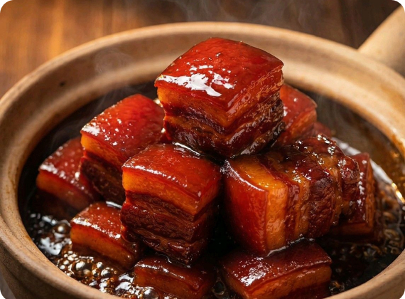 Cubes of red-braised Dongpo pork belly in a clay pot