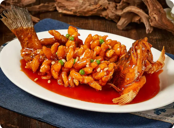 Squirrel-shaped mandarin fish in sweet-and-sour sauce on a white platter