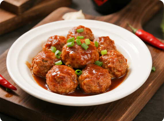 Braised pork balls in brown sauce on a white plate