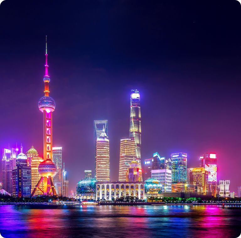 The Pudong skyline lit up at night across the Huangpu river, Shanghai