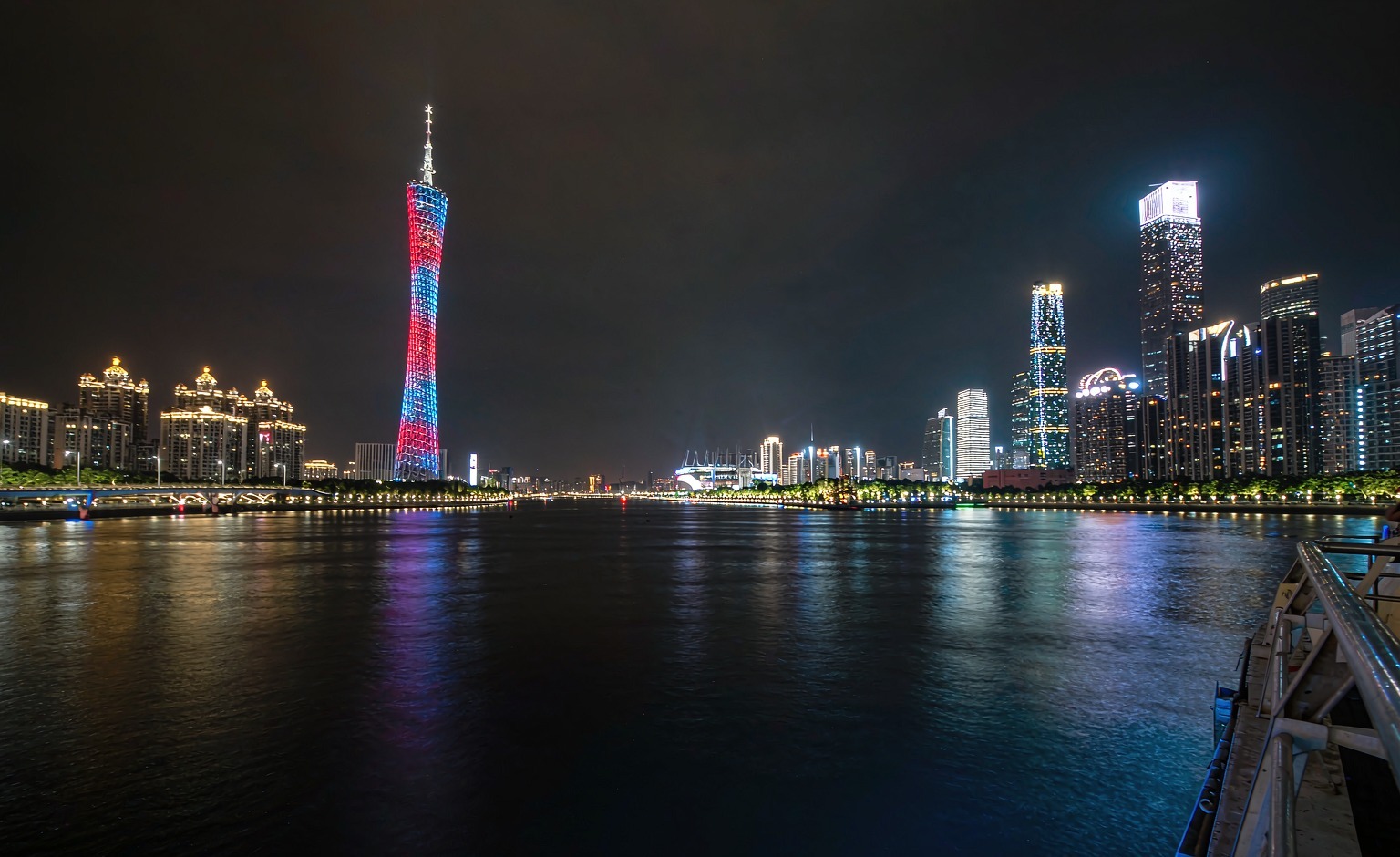 The Canton Tower lit red and blue across the Pearl River at night